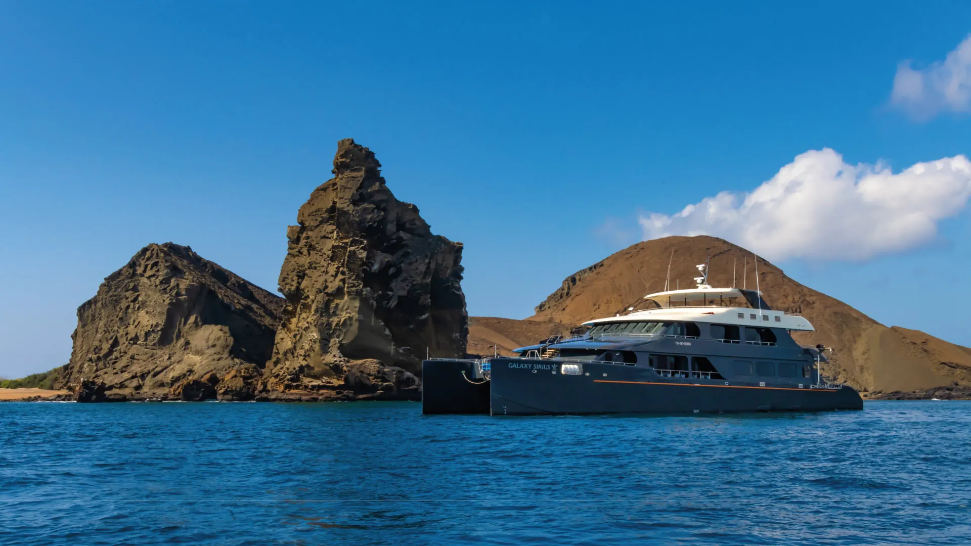 Galaxy Sirius Cruise sailing near Bartolome Island