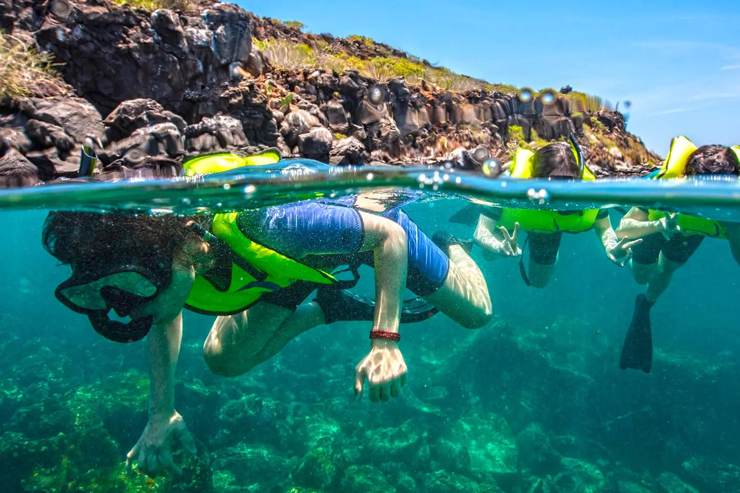 Family snorkeling in clear Galapagos water